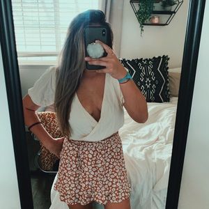 Cream colored crossover top.